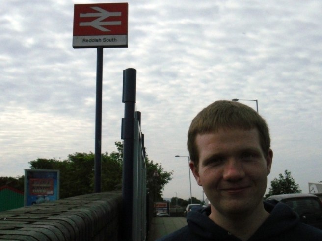 Robert in front of the Reddish South sign Picture of Robert in front of the Reddish South station sign