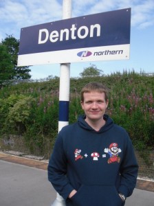 Robert Hampton at Denton Photo of Robert standing under the Denton station sign