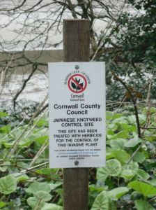 Photo of sign warning that this area has been treated with Herbicide for Japanese Knotweed