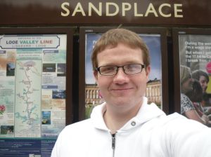 Photo of Robert in front of Sandplace station sign