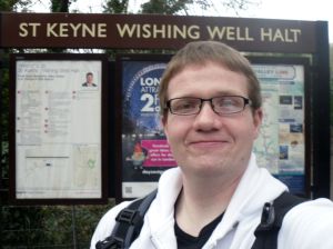 Photo of Robert posing under the St Keyne Wishing Well Halt sign