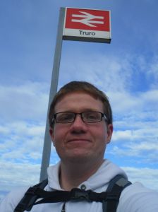 Robert standing under the Truro station sign