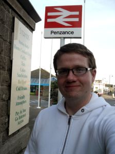 Robert standing under the Penzance sign